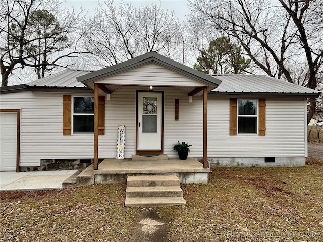 view of front of home featuring a garage and a porch