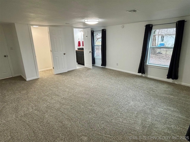 unfurnished bedroom featuring carpet flooring and a textured ceiling