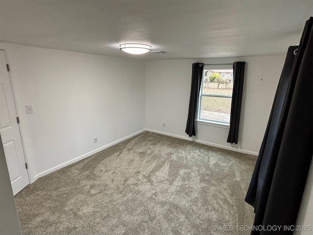 empty room featuring carpet and a textured ceiling