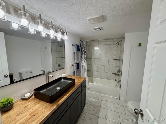 full bathroom with toilet, vanity, shower / bathtub combination with curtain, and a textured ceiling