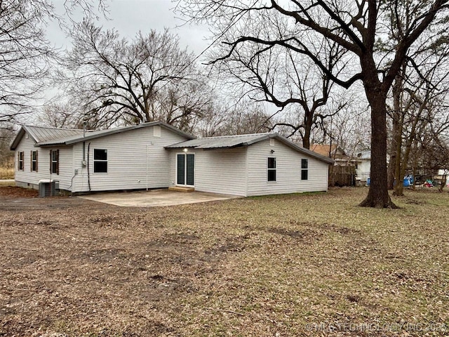 rear view of house featuring a yard and a patio area