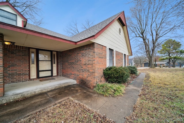 property entrance with a lawn