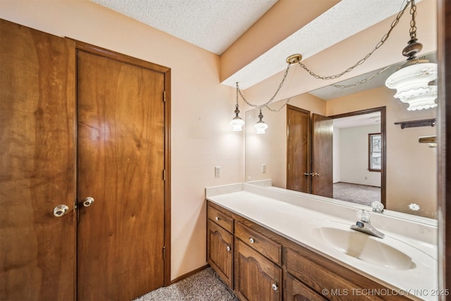 bathroom with vanity and a textured ceiling