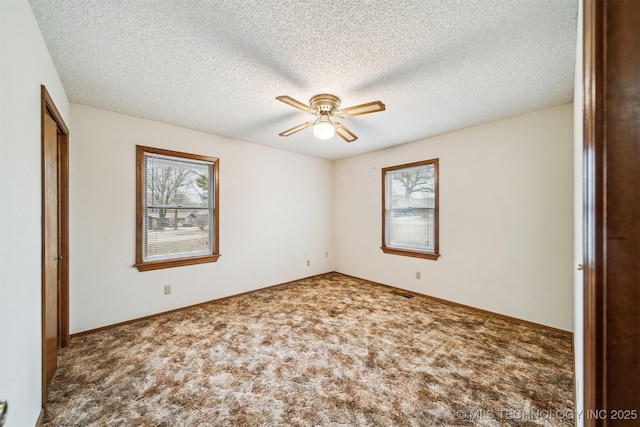 unfurnished bedroom with ceiling fan, carpet, a textured ceiling, and a closet