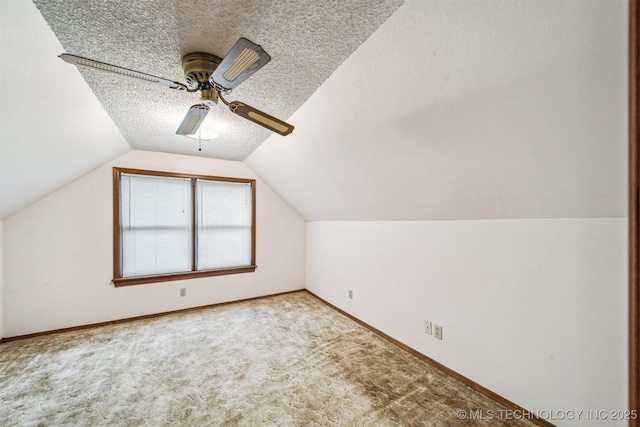 bonus room with ceiling fan, light colored carpet, vaulted ceiling, and a textured ceiling