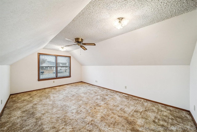 bonus room featuring carpet floors, ceiling fan, vaulted ceiling, and a textured ceiling