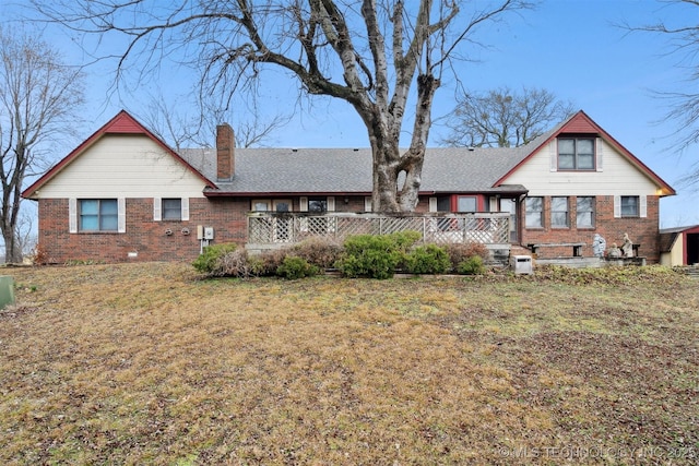 rear view of property featuring a yard