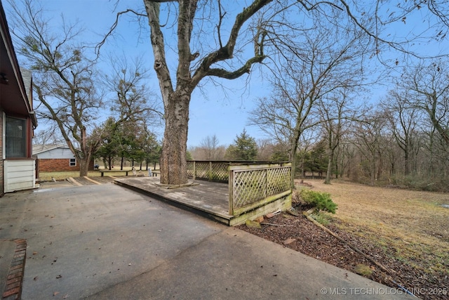 exterior space featuring a wooden deck and a patio area