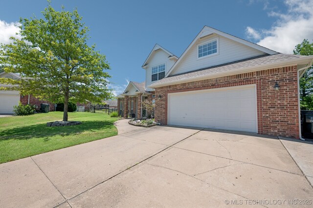 8402 N 100th E Ave, Owasso, OK 74055 - traditional-style house featuring brick siding, a front yard, roof with shingles, driveway, and a garage