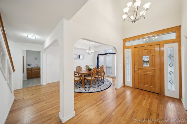 entrance foyer featuring hardwood / wood-style flooring and a notable chandelier