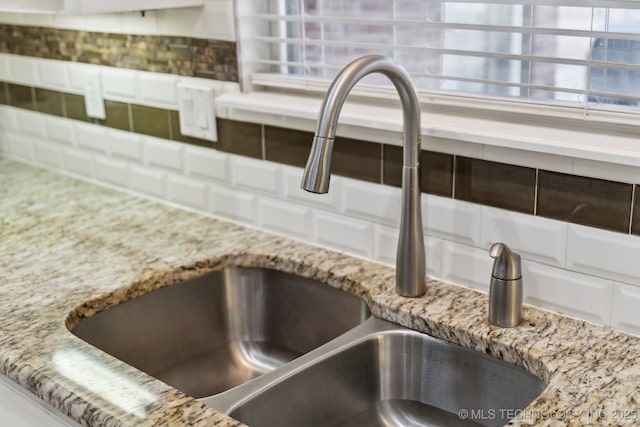 interior details featuring stone counters and sink