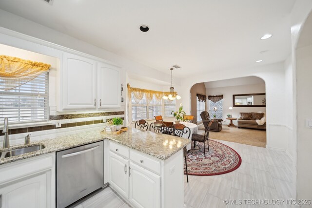 kitchen featuring pendant lighting, white cabinets, sink, and dishwasher