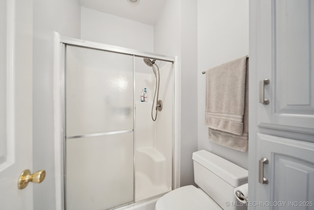 bathroom featuring toilet and walk in shower