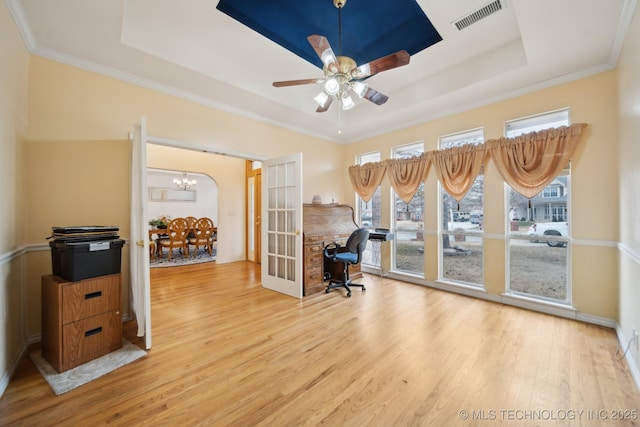 home office with french doors, wood-type flooring, crown molding, and a raised ceiling