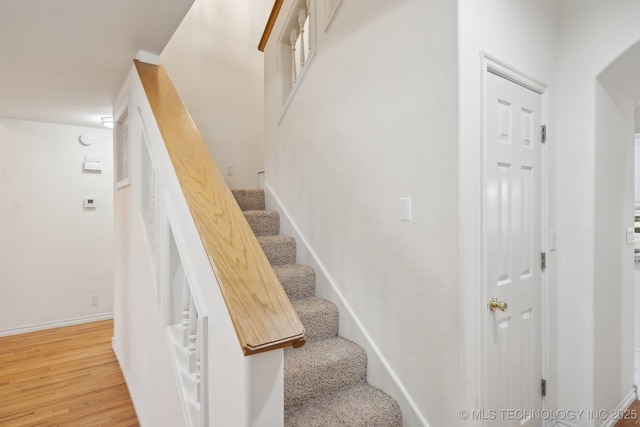 stairs with hardwood / wood-style floors