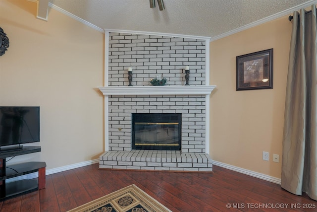 living room with dark hardwood / wood-style flooring, crown molding, a fireplace, and a textured ceiling