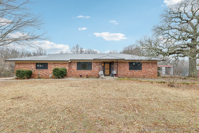 single story home featuring a front lawn and brick siding