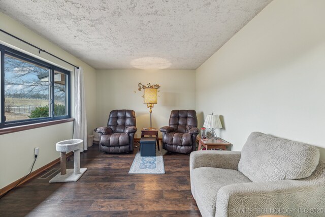 living room with dark wood-type flooring and a textured ceiling