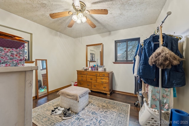 interior space with ceiling fan, dark hardwood / wood-style floors, and a textured ceiling