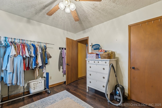 bedroom with ceiling fan, dark hardwood / wood-style floors, and a textured ceiling