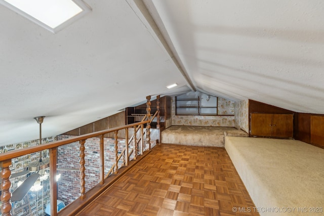 additional living space with parquet floors, wooden walls, a textured ceiling, and vaulted ceiling with beams