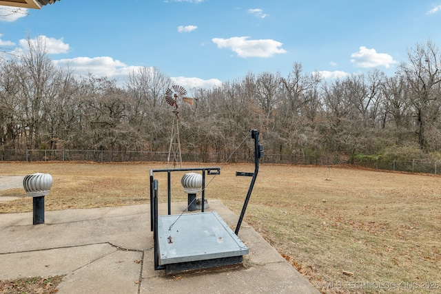 entry to storm shelter with fence and a lawn