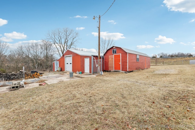 exterior space featuring an outbuilding and a garage