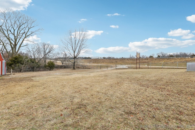 view of yard featuring a rural view and fence