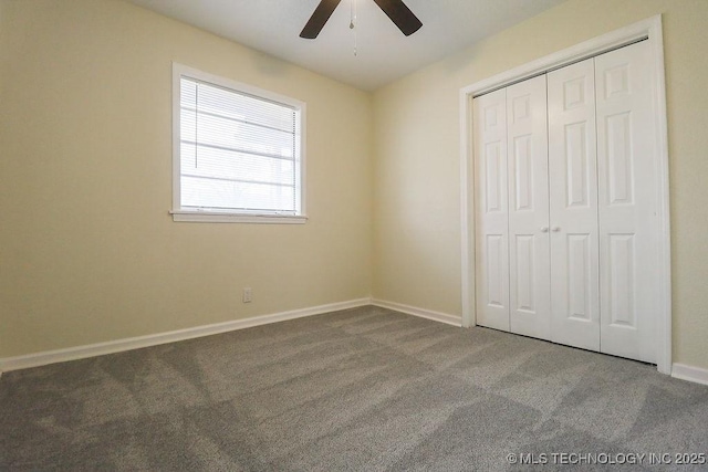 unfurnished bedroom featuring carpet, ceiling fan, and a closet