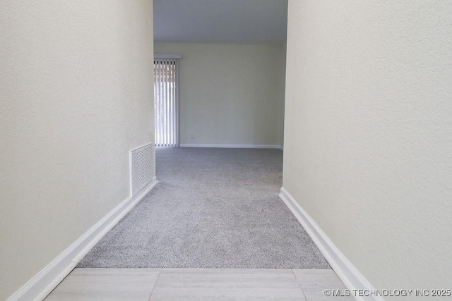 corridor with light colored carpet