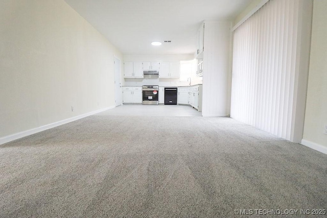 unfurnished living room with sink and light carpet