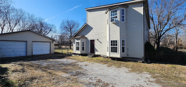 view of home's exterior with an outbuilding, a garage, and cooling unit