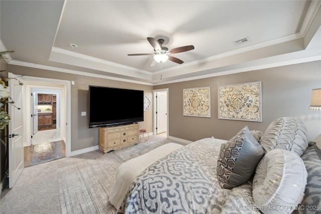 bedroom featuring ornamental molding, a raised ceiling, and ceiling fan