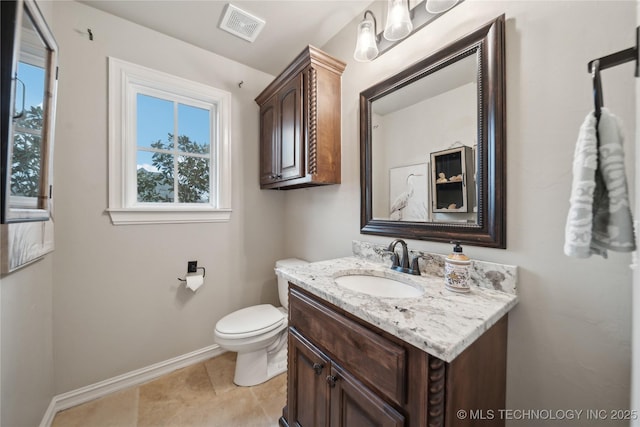 bathroom with vanity, toilet, and tile patterned flooring