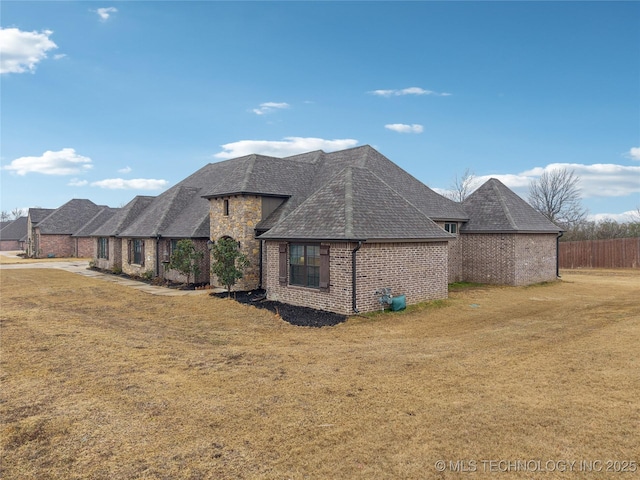 rear view of property featuring a yard