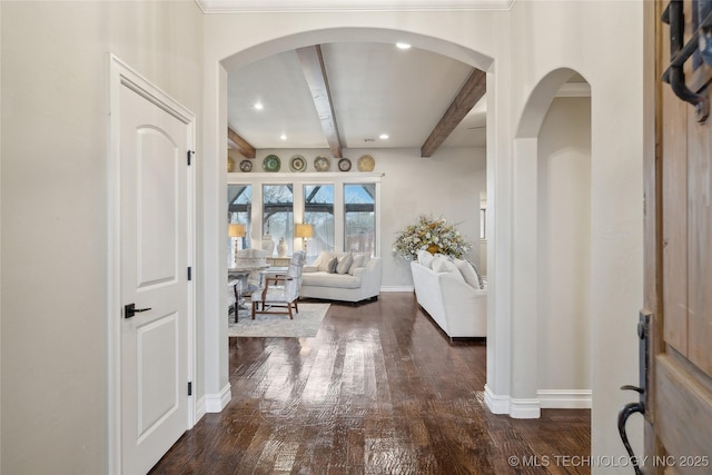 interior space with beamed ceiling and dark hardwood / wood-style floors