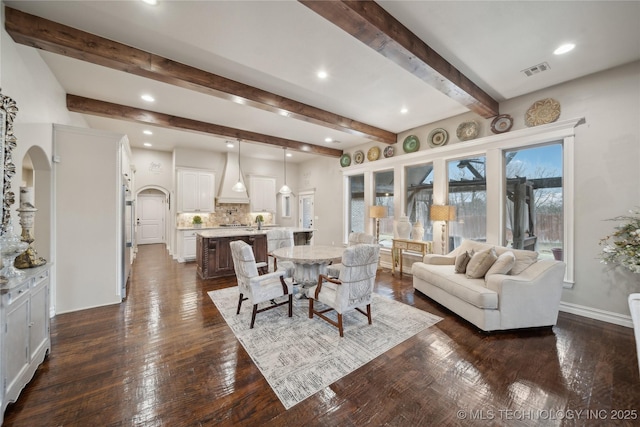 living room featuring dark hardwood / wood-style flooring and beam ceiling