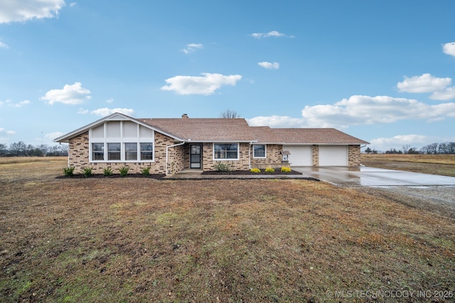 ranch-style home with a garage and a front lawn