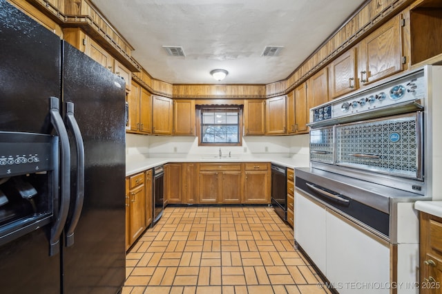 kitchen with sink and black appliances