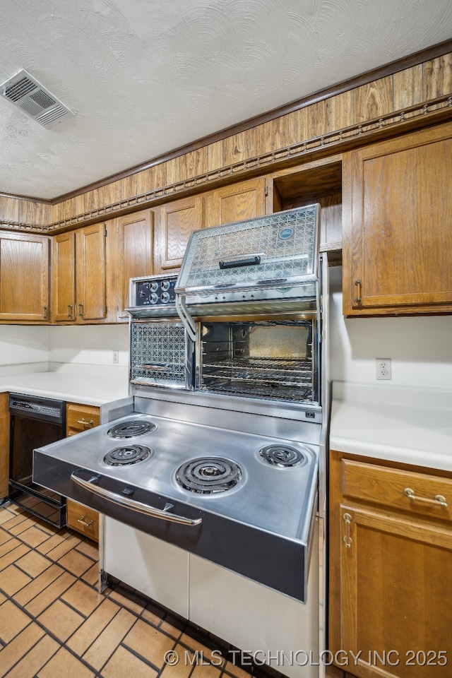 kitchen featuring a textured ceiling and black dishwasher