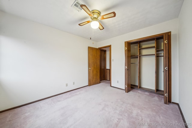 unfurnished bedroom with ceiling fan, a closet, and light carpet