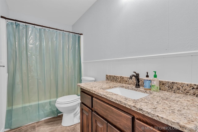 full bathroom featuring vanity, shower / bath combo, and toilet