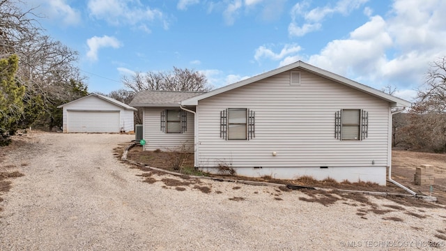 view of front of home with a garage and an outdoor structure