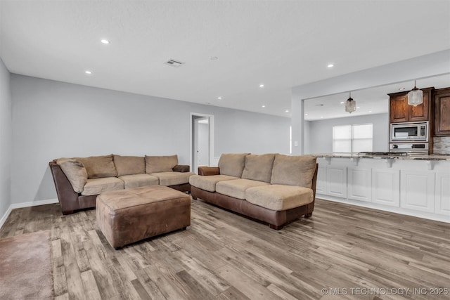 living room with light hardwood / wood-style floors