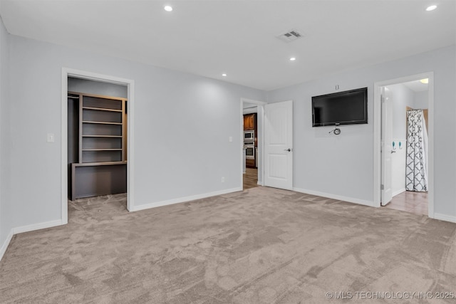 interior space featuring a spacious closet and light colored carpet