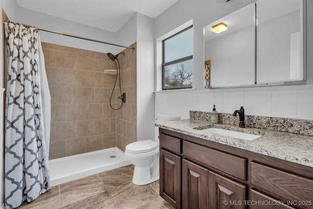 bathroom featuring vanity, curtained shower, and toilet