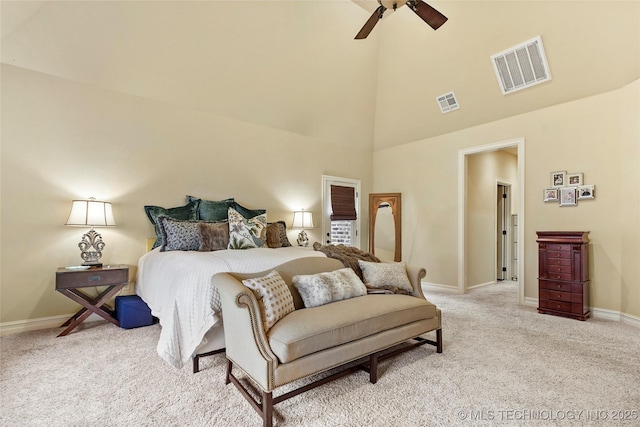 carpeted bedroom featuring a towering ceiling and ceiling fan