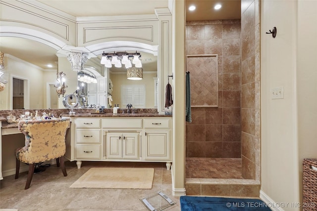 bathroom featuring a tile shower, vanity, and ornamental molding