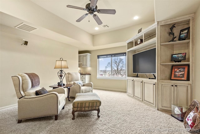 carpeted living room featuring ceiling fan