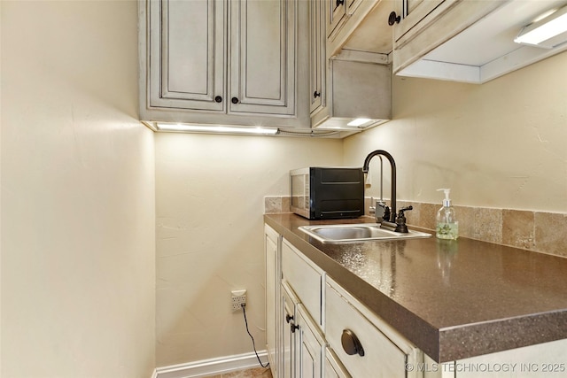 kitchen featuring sink and cream cabinetry